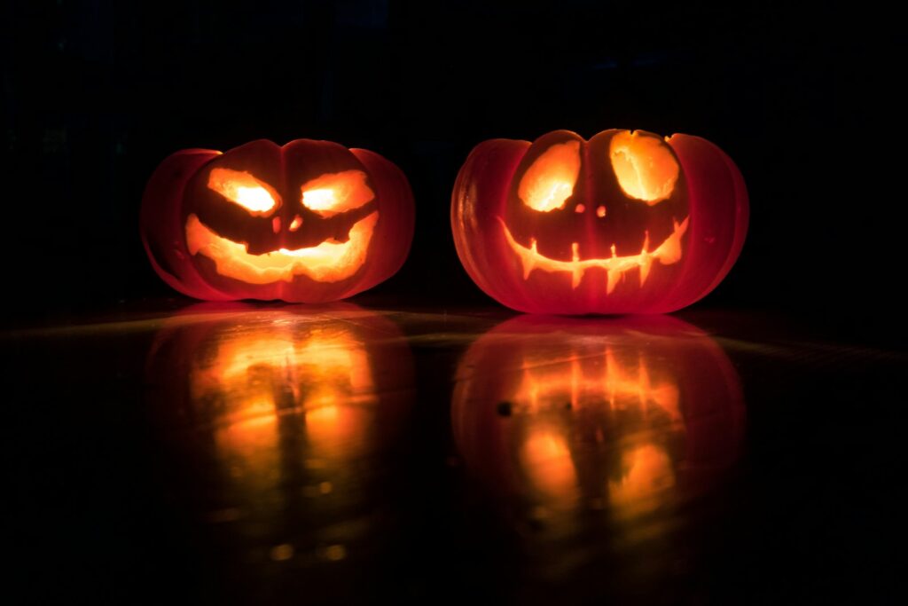 Two carved Halloween pumpkins that glow in the dark